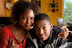 African-American woman with young man in kitchen