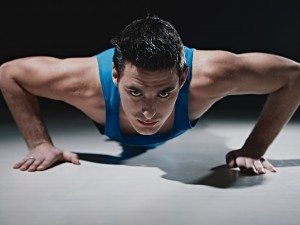 Man doing push-ups on black background