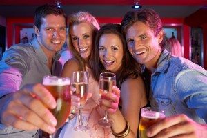 Group Of Young People Having Fun In Busy Bar