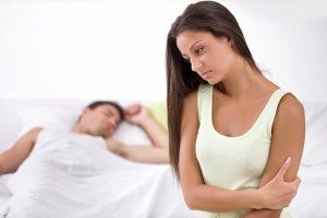 unhappy young woman in bedroom