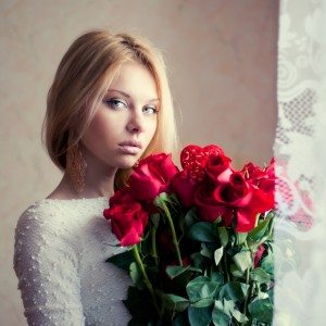 portrait of a beautiful blonde with a bouquet of roses