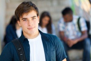 highschool boy with friends on background