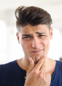 Unsure, confused, puzzled young man