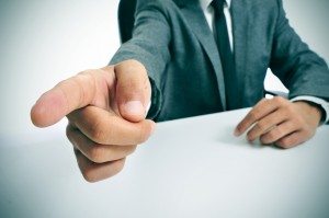 man in suit pointing with the finger the way out