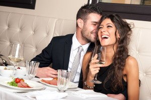 Attractive elegant young couple drinking a cocktail at the resta