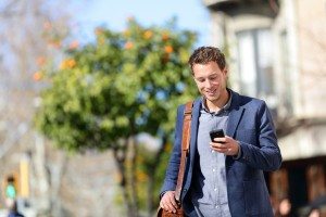 Young urban professional man using smart phone