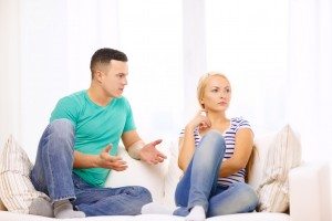 unhappy couple having argument at home