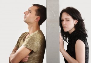 Conflict between man and woman standing on either side of a wall