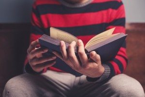 Man is reading a big book