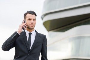 Attractive young businessman on the phone in an office building