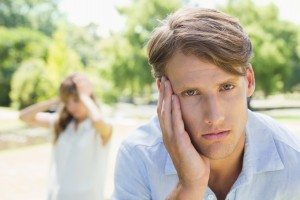 Upset man looking at camera after a fight with his girlfriend in