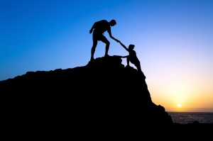 Man and woman couple help silhouette in mountains