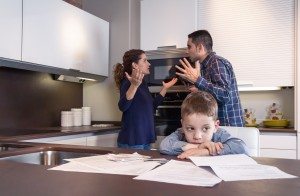 Sad child suffering and parents having discussion