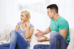 unhappy couple having argument at home