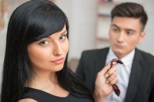 Businesswoman flirting and pulling her colleague by the tie, rel