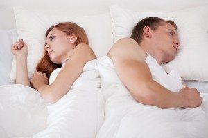 Couple lying back to back