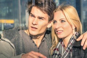 Young couple of lovers behind glass reflections - Handsome man a