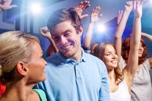 smiling friends at concert in club