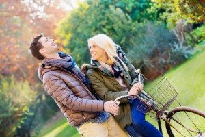 autumn. couple cycling in park