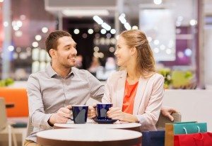 happy couple with shopping bags drinking coffee