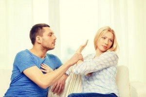 unhappy couple having argument at home