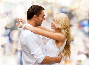 happy couple hugging over lights background