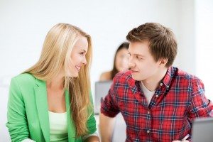 smiling students looking at each other at school