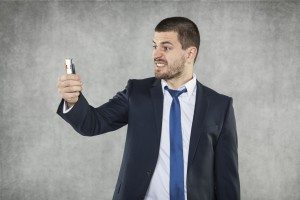 angry businessman with a phone in his hand