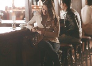 Attractive woman sitting at the bar counter