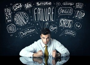 Depressed businessman sitting under trouble thought boxes