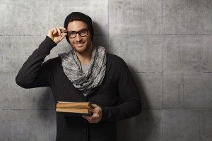Happy young man reading book