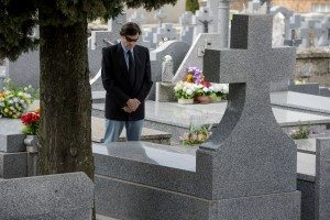 Man praying in the tomb of a cemetery