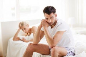 unhappy couple having problems at bedroom