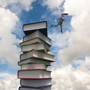 Composite image of businessman jumping holding an umbrella