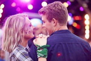 Couple looking at each other in the crowd at music festival