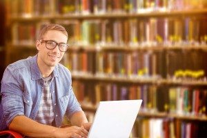 Composite image of hipster on laptop