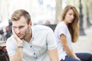 Portrait of young woman and man outdoor on street having relationship problems