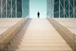 Businessman on the top of stairway between business centers outd
