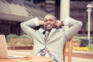 happy businessman relaxing sitting at table outdoors corporate office