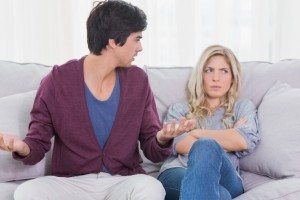 Young couple having an argument at home on the couch